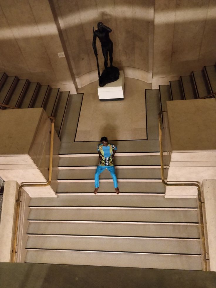 a person standing on some stairs in a building