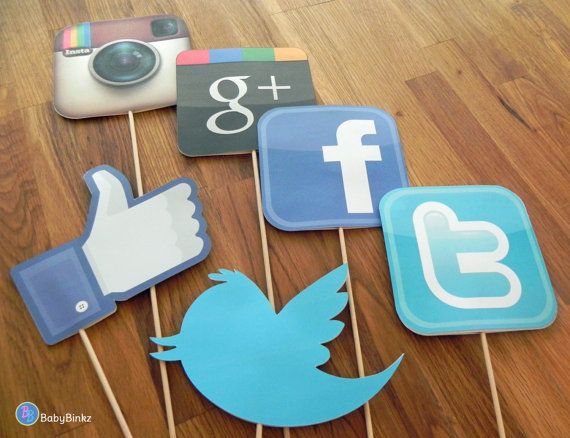 some social media stickers on a wooden table