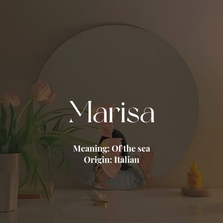 a woman sitting at a table with flowers in front of her and the words marina on it