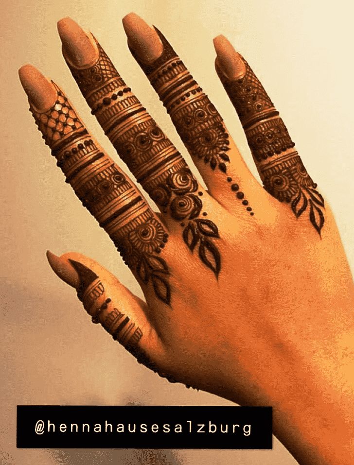 a woman's hand with henna tattoos on it