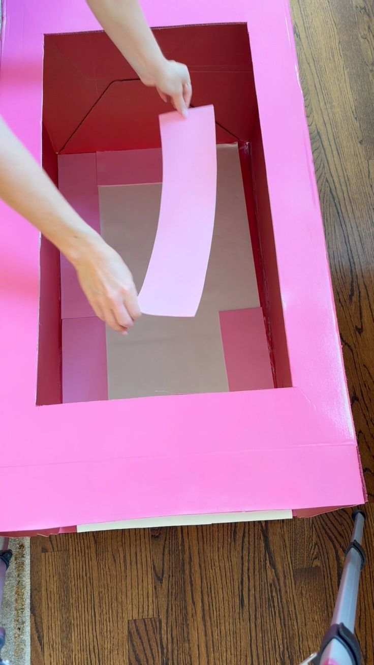 someone is making a box out of cardboard