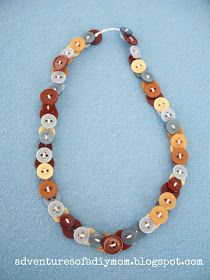 a necklace made out of buttons on a blue background