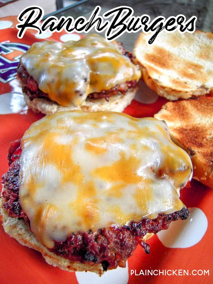 three hamburger patties with cheese on them sitting on a red and white plate