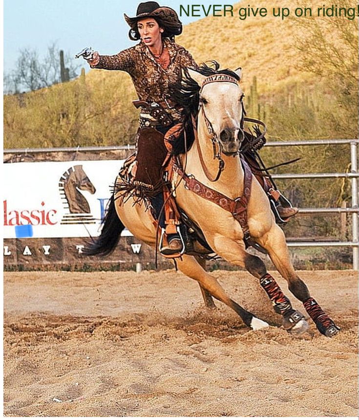 a woman riding on the back of a white horse in an arena with words never give up on riding