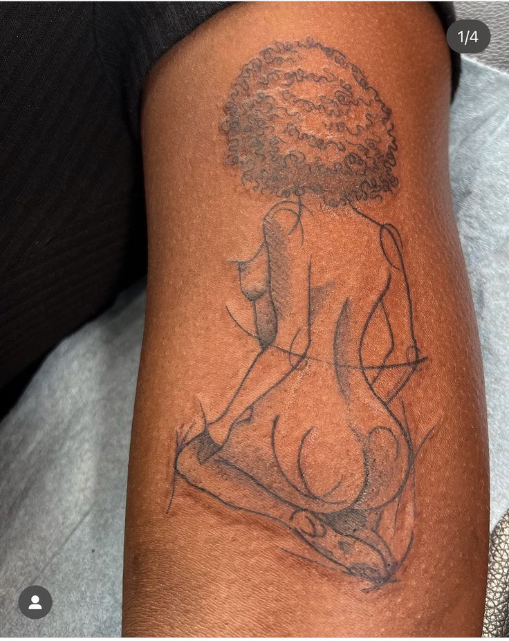 a woman's arm with a tattoo on it that has a drawing of a woman