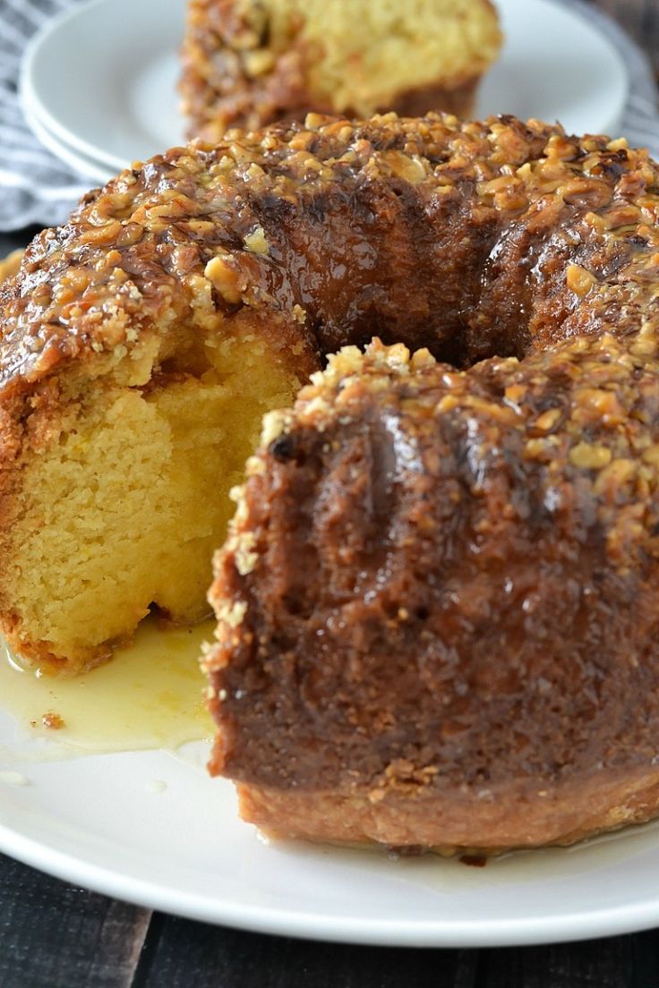 a bundt cake on a white plate with one piece cut out and the other half eaten