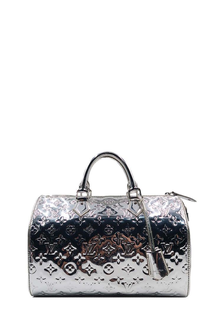 38% off retailEstimated Retail Price: S$4350DescriptionThis stunning and extremely rare Louis Vuitton Limited Edition Silver Monogram Miroir Speedy 30 Bag. It features ultra-shiny monogram mirrored vinyl with patent leather trim and a padlock. The top unzip to a spacious fabric interior. This celebrity-coveted bag is a must-have for all Louis Vuitton collectors everywhere.MaterialExterior: PatentInterior: FabricMeasurements (cm) Length Height Width Top Handle Strap Drop 33 23 19 10 - Detachable Silver Louis Vuitton Bag, Silver Louis Vuitton, Rare Louis Vuitton, Mirror Vinyl, Designer Bags Louis Vuitton, Exterior Hardware, Louis Vuitton Limited Edition, Silver Monogram, Bag Jewelry