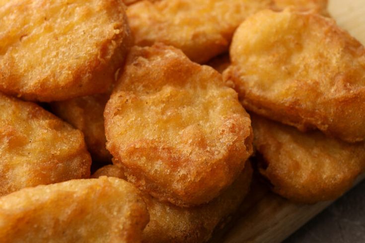 some fried food is sitting on a cutting board