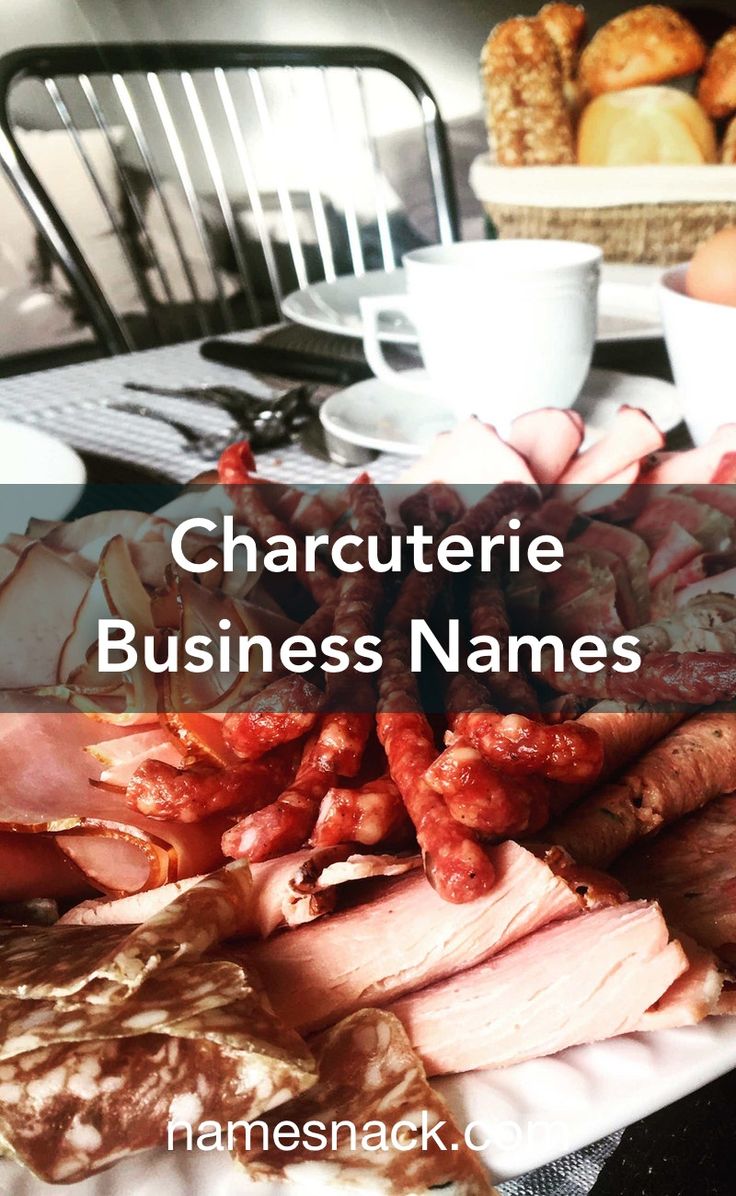 charcuterie business names on a plate with breads and croissants in the background