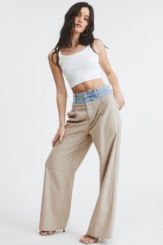 Introducing our one-of-a-kind Billie Trousers, where casual meets dressy in perfect harmony.These trouser pants are designed with a unique Peek-a-boo denim wash waistband that adds a playful twist to the sophisticated pinstripe pattern. Complete with functioning front pockets and belt loops on both the denim and pants, they seamlessly blend style and practicality. PRE ORDER APRIL 26TH Fabric & fit: SELF: 69% POLYESTER 29% RAYON 2% SPANDEXCONTRAST: 100% COTTONModel is wearing size Small. Dressy Shirts, Romper And Jacket, European Design, European Designs, Boho Look, Swimwear Sale, Peek A Boo, Trouser Pants, Event Dresses