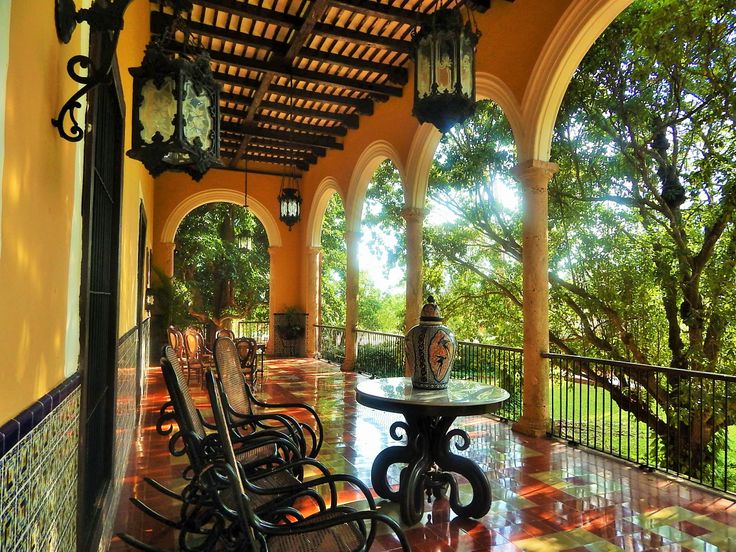 an outdoor patio with chairs and tables on it