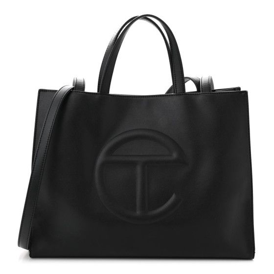 This is an authentic TELFAR Vegan Leather Medium Shopping Bag in Black.This is a tote crafted of synthetic leather in black with the iconic raised Telfar logo at the front. The shoulder bag has short top handles, and two long shoulder straps. The top secures with a magnet snap and opens toa black fabric-lined interior with a zippered pocket. Black Leather Satchel With Logo, Evening Leather Bag With Embossed Logo, Black Top Handle Satchel With Logo, Tan Leather Bag With Logo, Leather Bags With Embossed Logo, Black Rectangular Satchel With Logo, Black Shoulder Bag With Embossed Logo, Evening Black Shoulder Bag With Embossed Logo, Formal Double Handle Bag With Logo