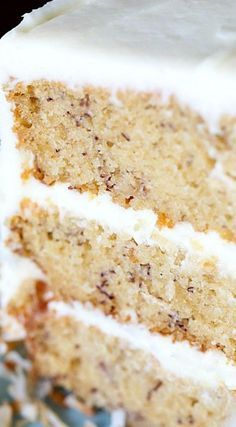 a slice of cake with white frosting on a plate