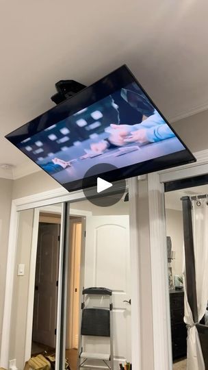 a flat screen tv hanging from the ceiling