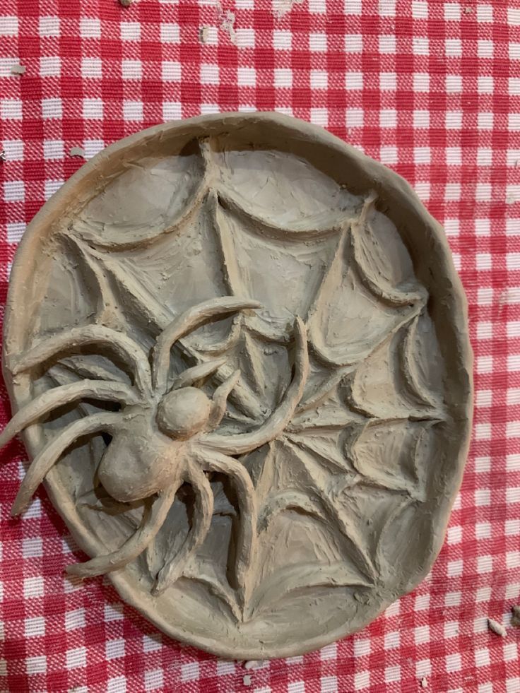 a bowl sitting on top of a red and white checkered table cloth