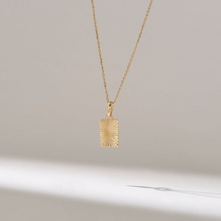 Rectangle Sun Pendant Features * Made to Order. * Gold KT: 14KT * Custom Gold Color: Yellow Gold * Charm 13.90mm x 9.50mm * Charm Thickness: 0.75mm * Ready to Ship in 5-7 Business Days ✓ We care about the environment,the jewelry we cast is made with recycled gold. We source exclusively post-consumer material that is refined back to their pure elements to ensure that the gold is in the same quality. Our designs are made from 14k/18k/10k real solid gold ✓ We care about customer satisfaction and lo Delicate Everyday Necklace With Rectangular Pendant, Delicate Rectangular Pendant Necklace For Everyday, Dainty Necklace With Rectangular Pendant, Elegant Rectangular Engraved Necklace, Minimalist Jewelry With Delicate Rectangular Chain, Minimalist Yellow Gold Square Pendant Jewelry, Minimalist Rectangular Jewelry With Delicate Chain, Gold Engraved Rectangular Charm Necklaces, Gold Engraved Rectangular Charm Necklace