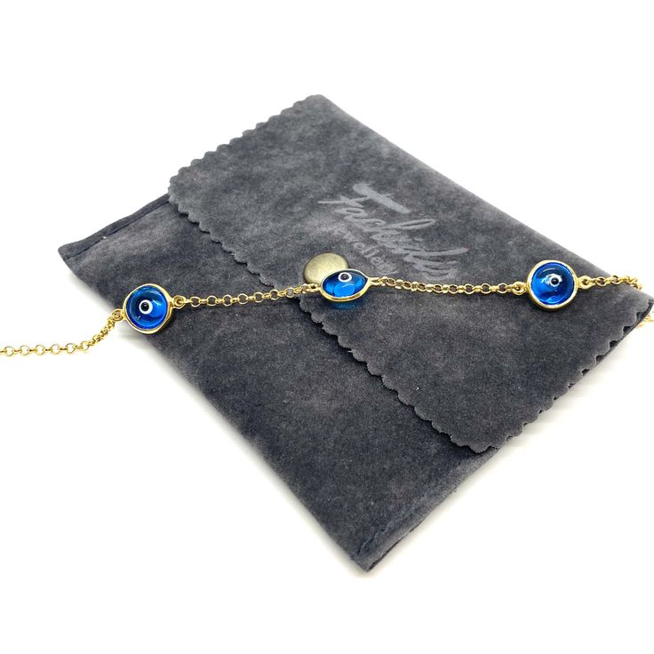 MELIGreece's memoir from the Greek islands, a 14k solid gold chain bracelet with three semi-transparent eye charms in a celestial blue color. Wearing a jewelry with an evil eye protects you from the negative energy around you. An easy to wear precious gold bracelet can be easily combined with your watch or your other bracelets. Yellow gold bracelet with three eye lucky charms in bright blue color with white and black enamel details, made in our workshop in Athens, Greece. Length of the bracelet: Luxury Bracelets With Delicate Chain, Luxury Delicate Chain Bracelet Gift, Luxury Gift Bracelets With Delicate Chain, Dainty Blue Chain Jewelry, Blue Gold Bracelet For Gift, Fine Jewelry, Fine Jewelry Blue Gold Bracelet For Gift, Elegant Round Chain Bracelet With Evil Eye, Blue Gold Bracelet For Gifts, Elegant Round Evil Eye Chain Bracelet