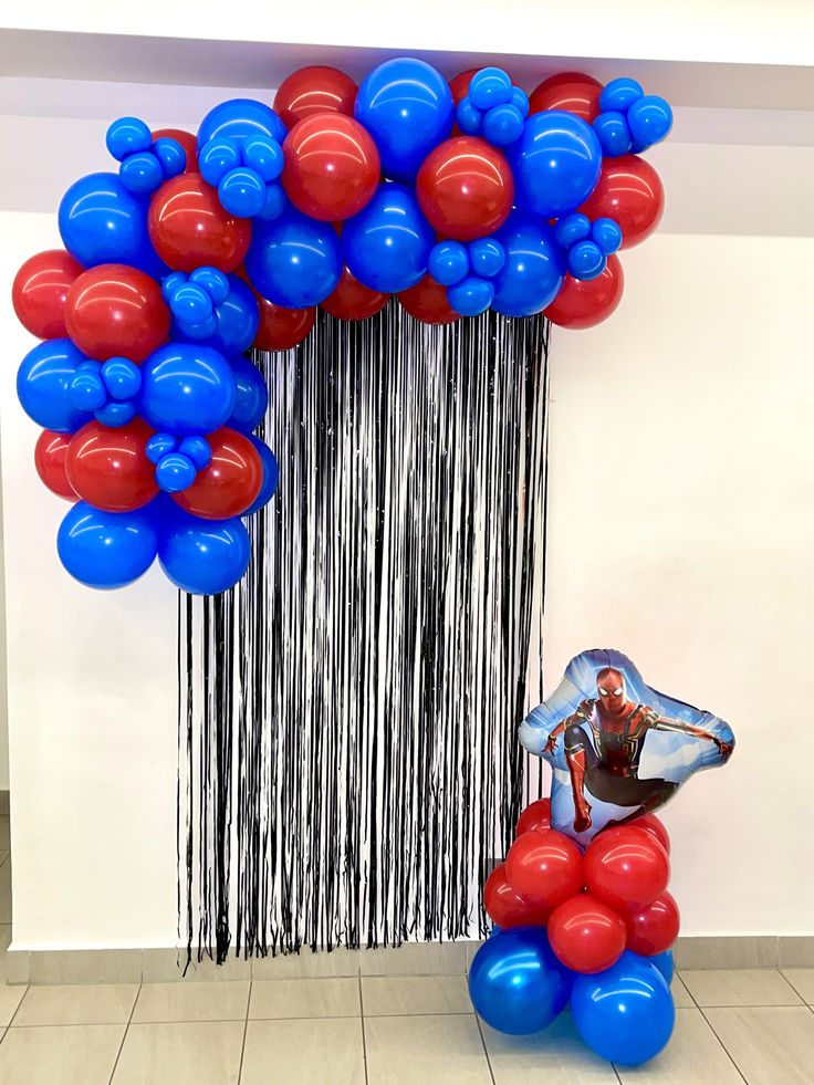 the balloon sculpture is decorated with red, white and blue balloons