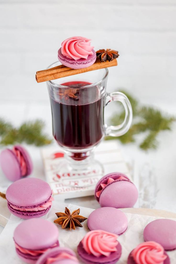 pink macaroons and cinnamon on a white table