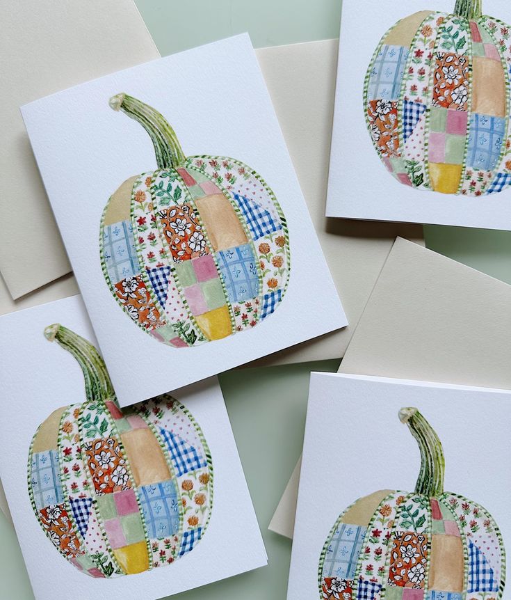 four cards with colorful patchwork pumpkins on them