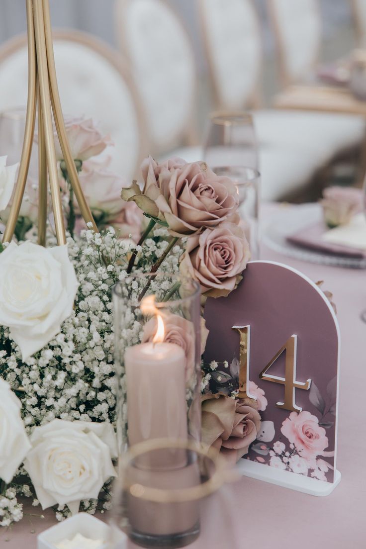 the table is set with flowers and candles