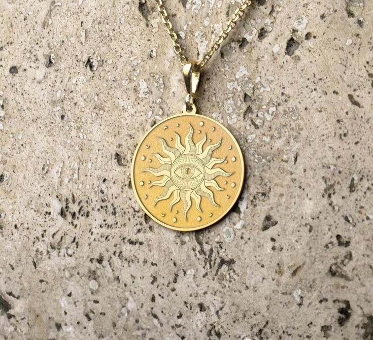 Embrace the mystique with this stunning  pendant necklace, featuring an intricate design of a radiant sun encircling an all-seeing eye. Crafted with meticulous attention to detail, this piece exudes a timeless elegance, perfect for adding a touch of celestial charm to any outfit. The pendant hangs gracefully on a durable chain, making it a versatile accessory for both casual and formal occasions. Elevate your jewelry collection with this unique and captivating sun and eye pendant necklace. - Mat Jewelry Reference, Gold Sun Necklace, Necklace Sun, Eye Pendant Necklace, Sun Charm, Sun Necklace, Sun Design, Chain Making, Sun Pendant