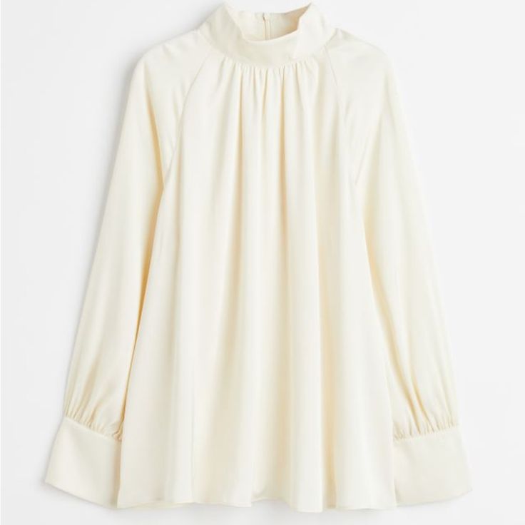 Blouse In Softly Draped Satin. Stand-Up Collar, Keyhole Opening At Back Of Neck With Covered Buttons, And Long, Raglan-Cut, Balloon Sleeves With Covered Buttons At Cuffs. Straight-Cut Hem. Size: Back: Length: 66.0 Cm (Size M), Sleeve: Length: 73.3 Cm (Size M) Feminine Fitted Top With Pleated Sleeves, Elegant White Long Sleeve Top For Fall, Spring High Neck Blouse For Work, Feminine Long Sleeve Tops With Pleated Sleeves, Fitted Tops With Pleated Sleeves For Daywear, High Neck Blouse For Spring Workwear, Elegant Beige Lantern Sleeve Top, White Long Sleeve Blouse With Pleated Sleeves, Elegant White Tops With Pleated Sleeves