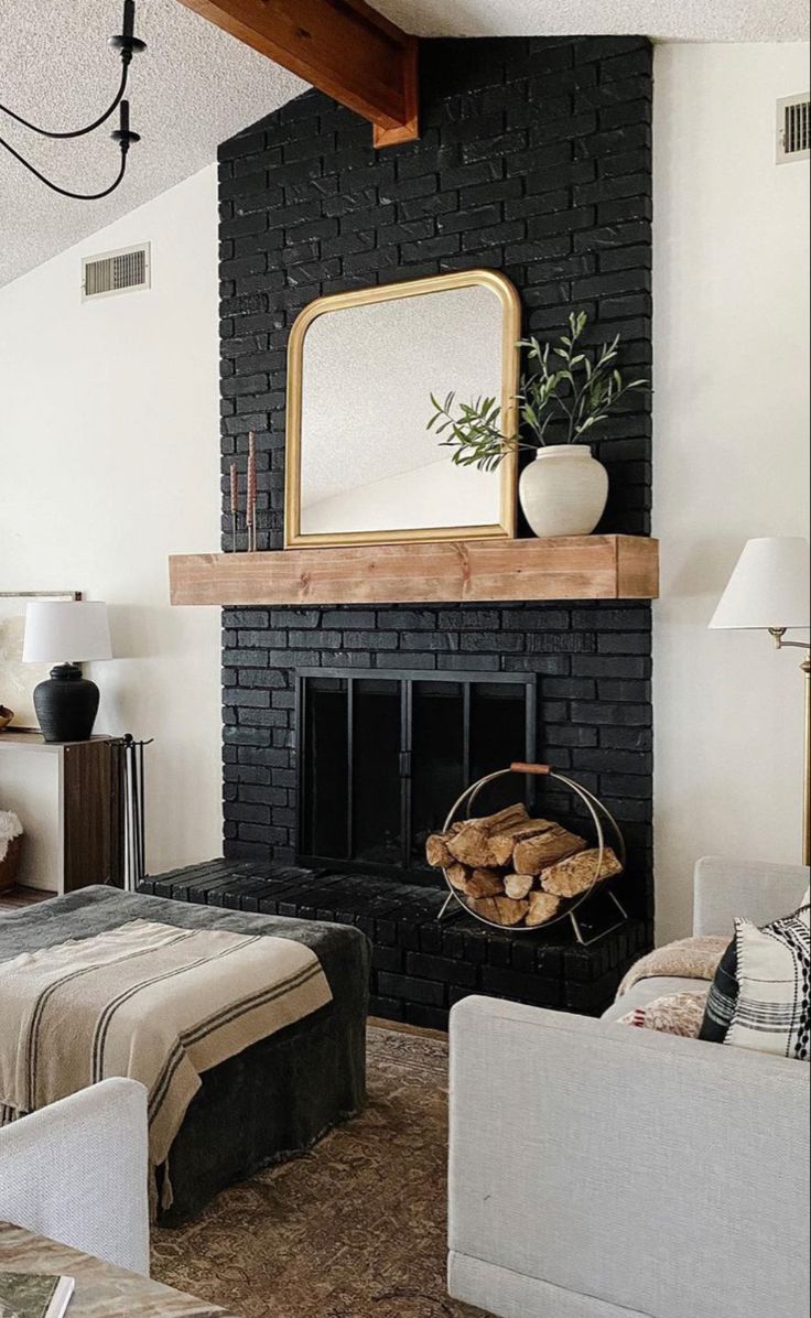 a living room filled with furniture and a fire place in front of a brick fireplace