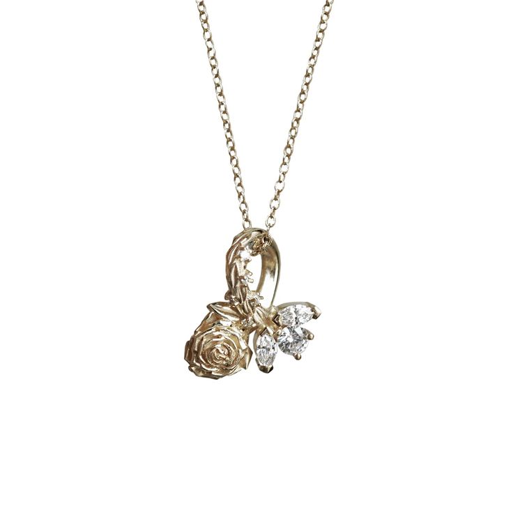 The Rosabelle necklace means "beautiful rose" that charms people with its one of a kind beauty. This necklace features a sculptured rose encrusted with tiny round natural diamonds on the stem, and marquises. Available in gold vermeil and 14K solid gold, and your choice of natural diamonds or CZ. Model is wearing an 16" gold filled chain necklace. Gold vermeil or 14k gold Natural diamonds or CZ Six natural round and marquise diamonds. Approx. 0.03ct total carat weight Pendant measures 15mm in len Elegant Rose Flower Pendant Charm Necklaces, Rose Gold Diamond Necklace With Charms, Elegant Necklace With Rose Flower Pendant, Wedding Necklace With Rose Cut Diamond Flower Pendant, Wedding Necklaces With Detachable Flower Pendant, Wedding Necklace With Detachable Flower Pendant, Wedding Flower Pendant Necklace With Rose Cut Diamonds, Wedding Flower Pendant Necklace With Detachable Feature, Elegant Rose Design Flower Pendant Necklace