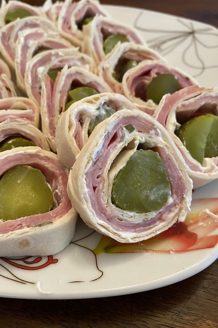 there are many different types of food on the plate together, including ham and olives