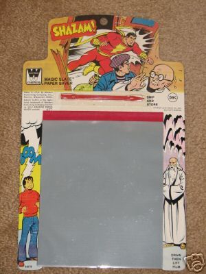 an assortment of comic related items are displayed on the floor, including a clipboard