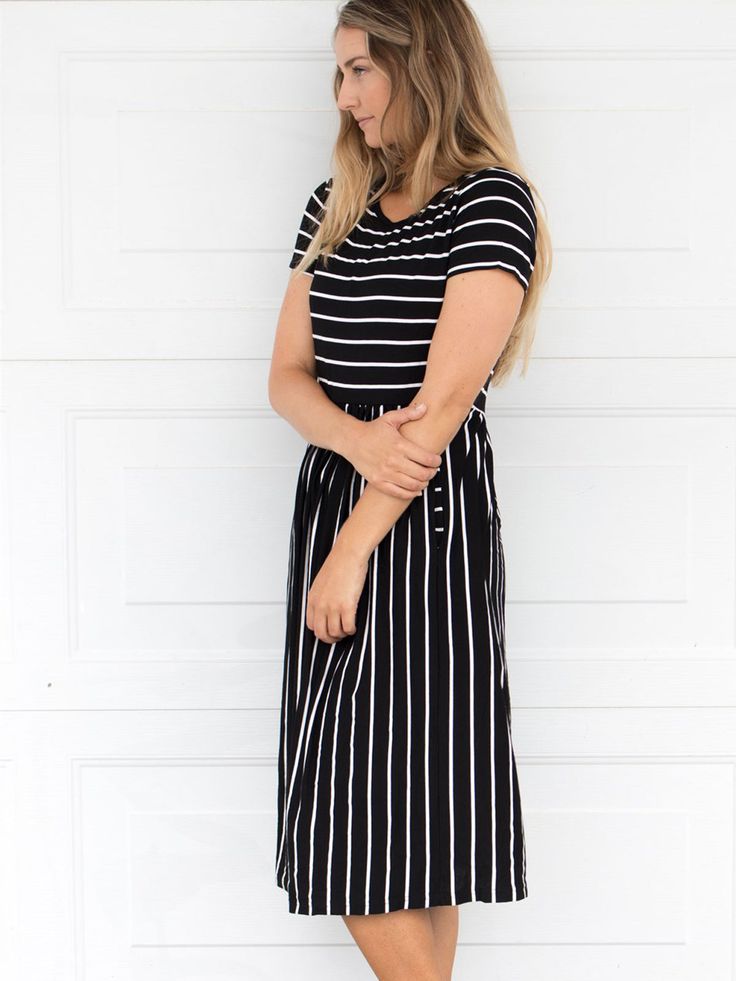 Looking for a dress that's both stylish and comfortable? Look no further than our Striped Midi Dress! With its classic stripes and midi-length, this dress is perfect for any occasion. Whether you're running errands or going out for a night on the town, this dress has got you covered. Pair it with a jean jacket and sneakers for a casual look, or dress it up with some great jewelry and heels for a more formal affair. Size: Small 0-4 Medium 6-8 Large 10-12 XL 12-14 Casual Striped Short Sleeve Midi Dress, Black Casual Dress With Striped Hem, Casual Black Dress With Striped Hem, Casual Spring Dresses With Contrast Stripes, Spring Striped Midi Dress, Striped Midi-length Spring Dress, Casual Striped Maxi Dress For Spring, Striped Casual Maxi Dress For Day Out, Striped Maxi Dress For A Casual Day Out