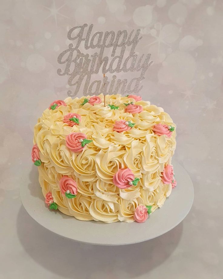 a birthday cake that is decorated with flowers and the words happy birthday written on top