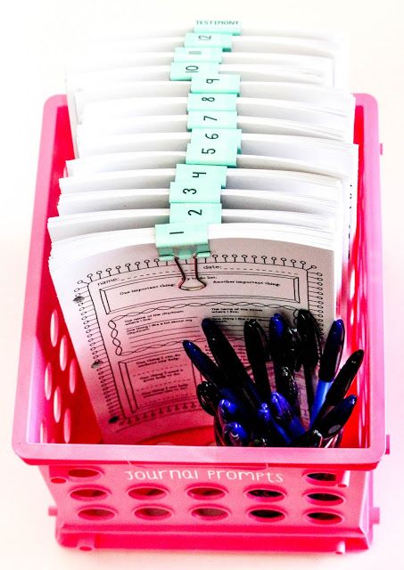 a pink basket filled with lots of papers