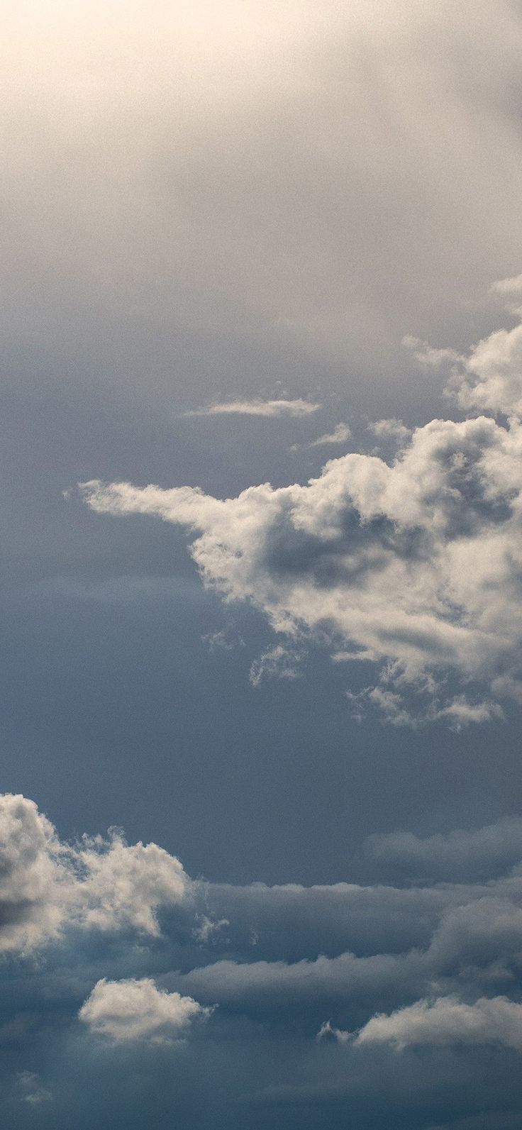 an airplane is flying through the cloudy sky