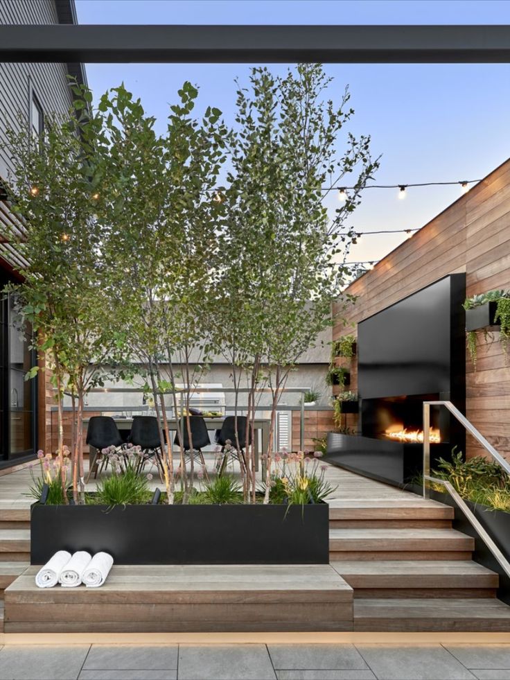 an outdoor living area with stairs and trees