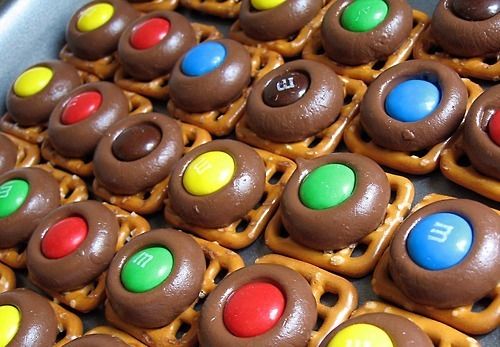 chocolate covered pretzels with m & m candies on them are ready to be eaten