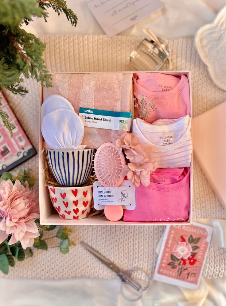 a box filled with lots of different items on top of a white cloth covered table