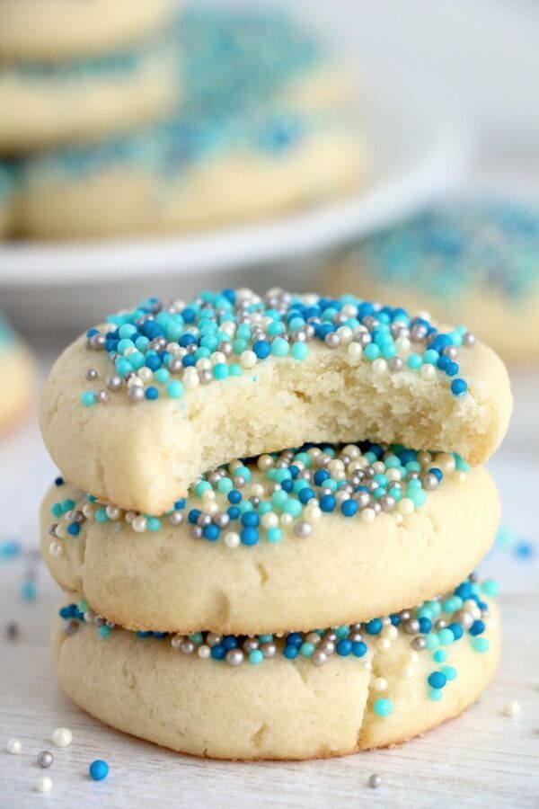 three cookies with blue and white sprinkles stacked on top of each other