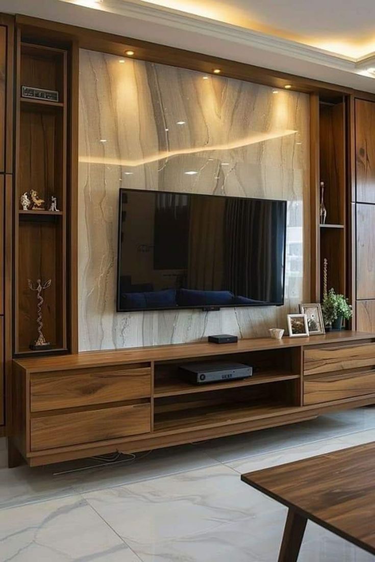 a living room with wooden furniture and a flat screen tv mounted to the side of a wall