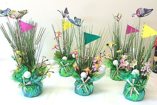 four vases with flowers and grass in them