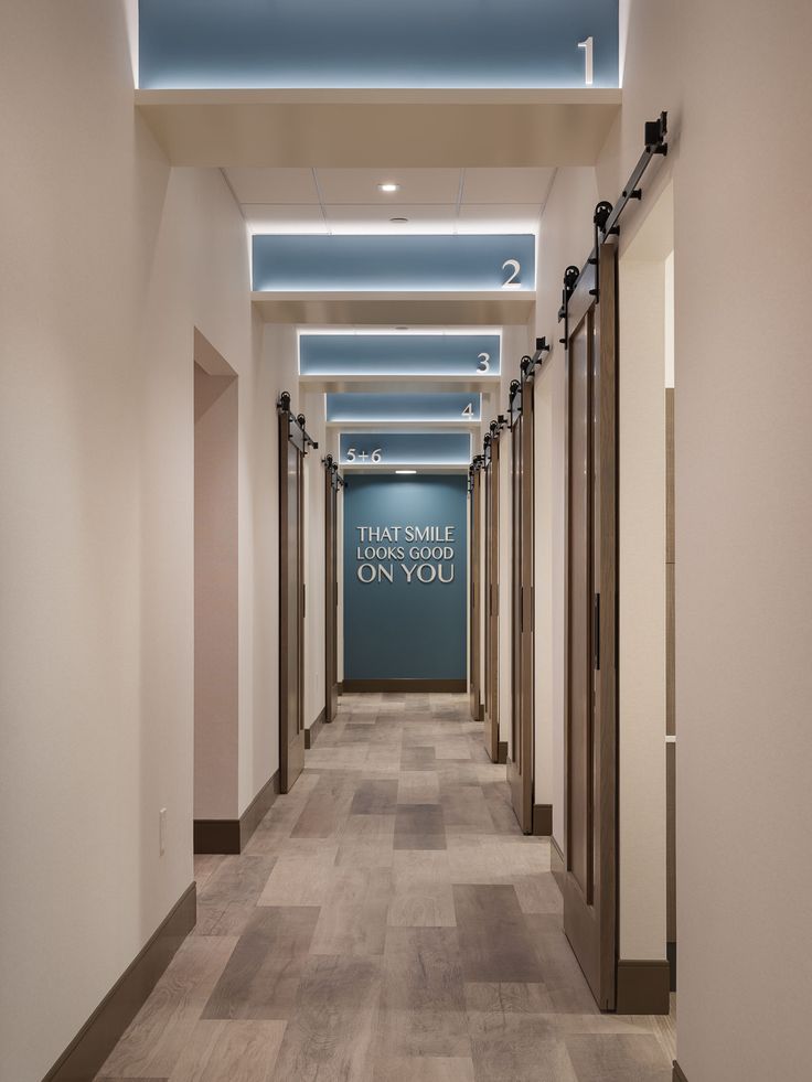 an empty hallway with blue and white signs on the walls