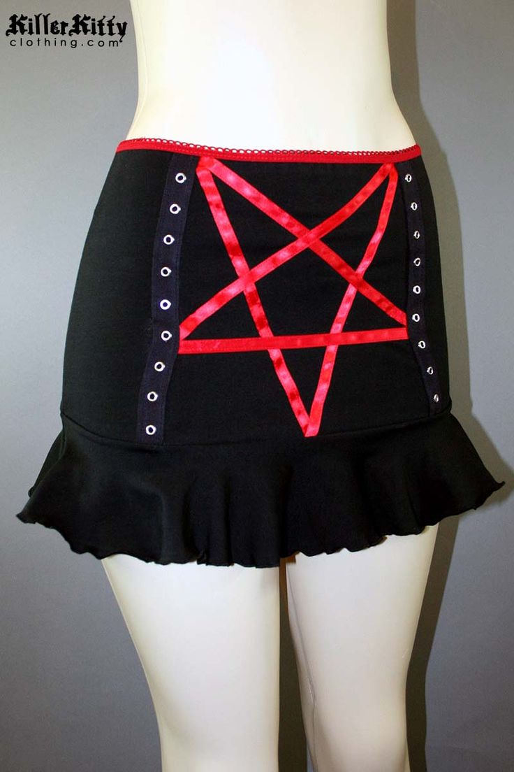 DETAILS Custom-made pentagram mini skirt created using red satin ribbon with black grommet tape on the front and a red elastic waist band. LENGTH: 13" (fits at hip) MODEL: Mannequin has 37" hip VIEW SIZE GUIDE CARE: Hand wash cold, hang dry. SHIPPING: Made When Ordered Please allow 1-2 WEEKS to ship. Red Rock Style Mini Skirt, Emo Fitted Mini Skirt, Rock Style Red Mini Skirt, Red Rock Mini Skirt, Gothic Mini Skirt For Halloween Festival, Gothic Halloween Festival Mini Skirt, Halloween Stretch Mini Skirt, Stretch Halloween Mini Skirt, Emo Fitted Mini Skirt For Cosplay