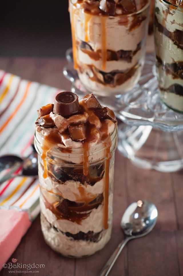 two desserts in glass jars with spoons next to them