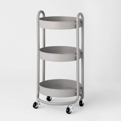 a three tiered serving cart with wheels on the front and bottom, in grey