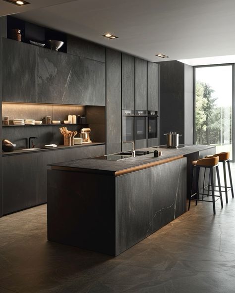 a modern kitchen with black cabinets and counter tops