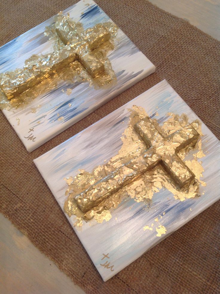 two paintings with gold foil on them are sitting on the floor next to each other