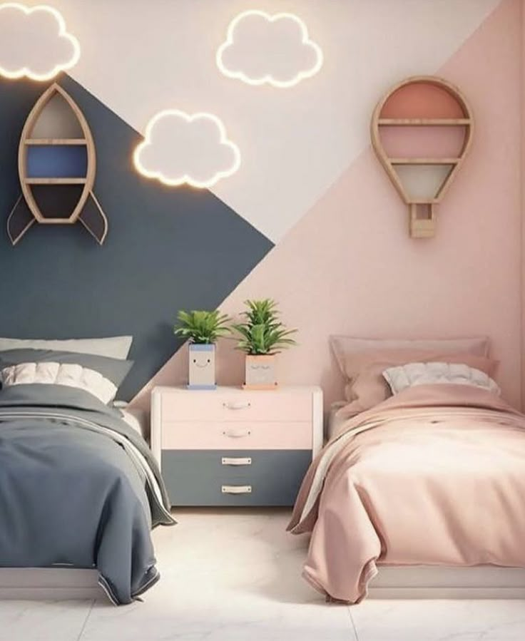 two beds in a room with pink and blue walls