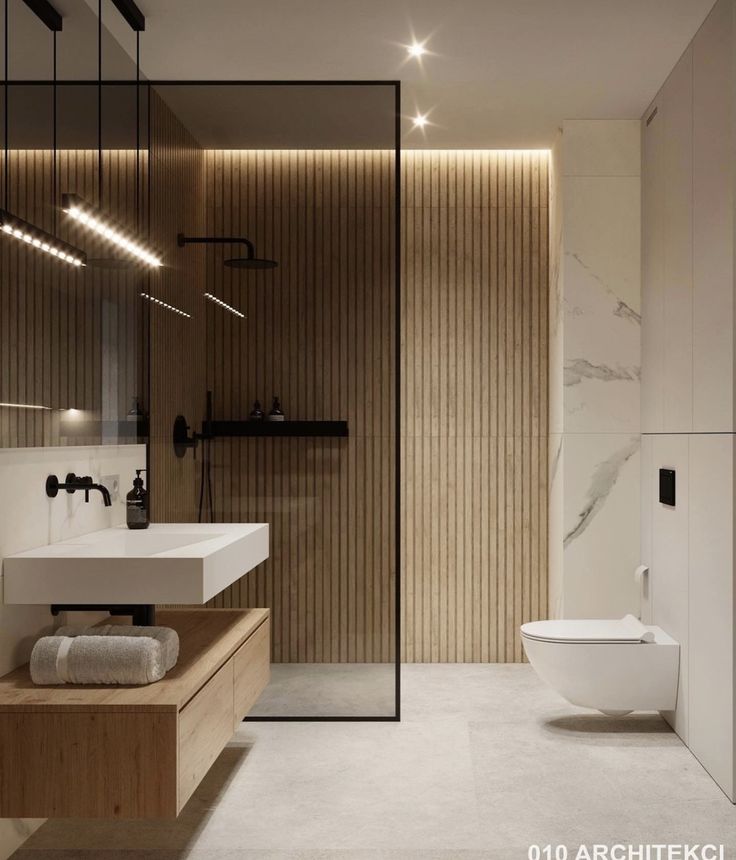 a bathroom with a toilet, sink and shower stall in it's center area