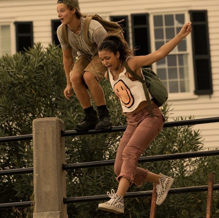 two people are riding skateboards on a rail